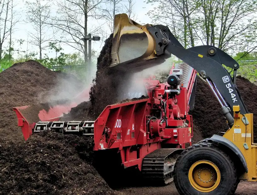 Landscaping services for mulch and planting beds around a home with fresh mulch and young shrubs