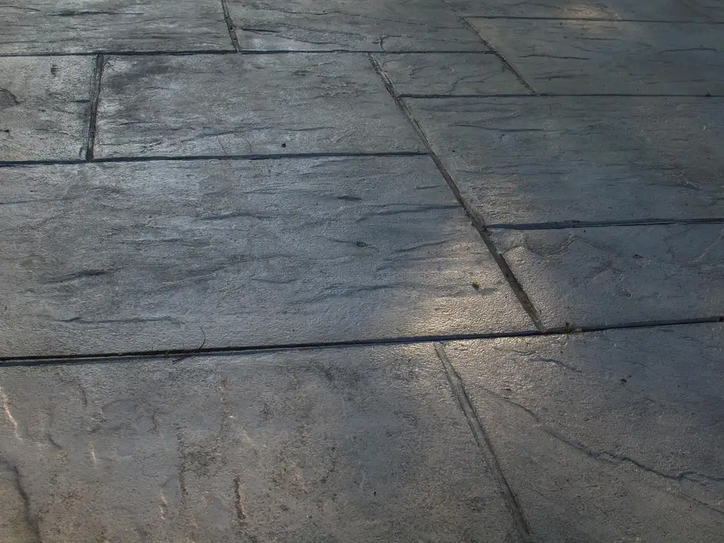 Landscaping services for patio and hardscape projects with pavers, gravel base, and retaining wall work in progress