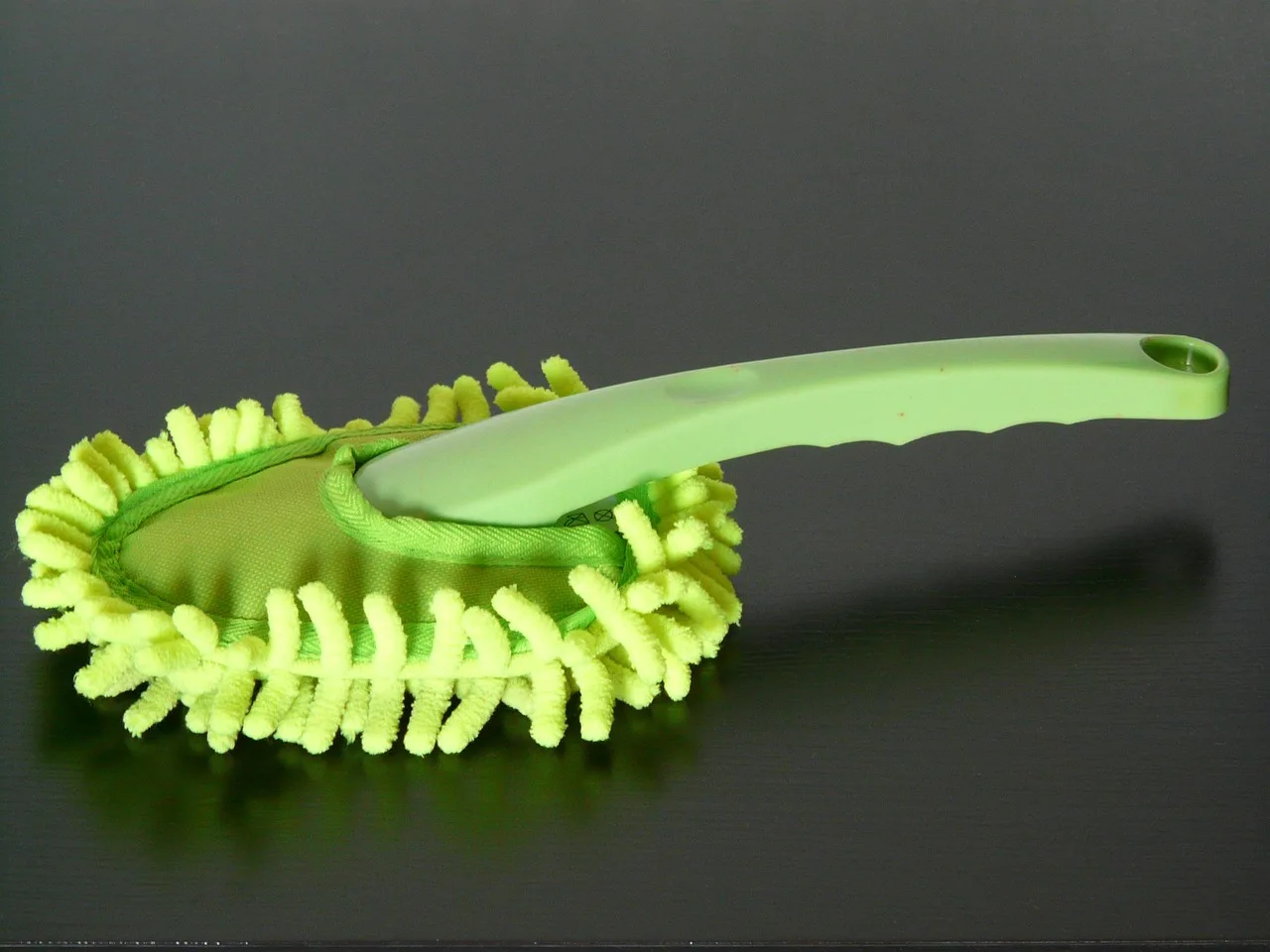 How do you clean dust off houseplant leaves without damaging them?
